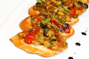 Bruschetta with stewed vegetables and Basil on fried garlic cheese bread. Selective focus. As backdrop for menus, cookbooks, advertisements and other culinary projects