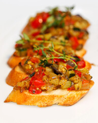 Bruschetta (Italian Toasted Garlic Bread) with stewed vegetables, selective focus. Creative cuisine. As backdrop for menus, cookbooks, advertisements and other culinary projects