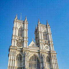 Fototapeta na wymiar Westminster Abbey Church against bright blue sky during sunset. Royal wedding was held here in United Kingdom, England, London, Westminster.