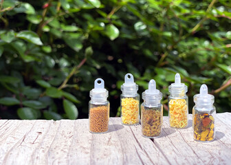 Yellow glitters for nail art and makeup in small glass jars isolated