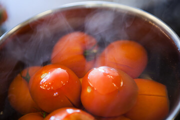 Blanching tomatoes in a metal pan