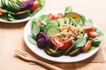Salad quinoa with vegetables on plate, Vegan food