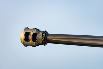 Barrel of 30 millimeter  automated small calibre machine gun located in the stern of the frigate that sails along the fleet in the background