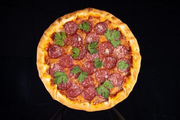 pizza with sausage on a black background for the restaurant menu1