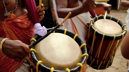 Indian men play traditional percussion drum Chenda in Kerala, India - Powered by Adobe