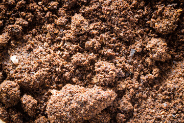background in the form of a young black instant coffee texture and piece of rock. closeup top view