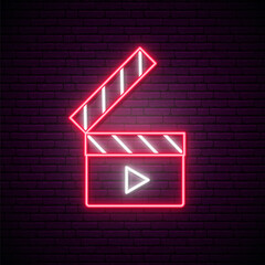 Neon clapperboard sign. Bright glowing clapperboard on dark brick wall background. Cinema emblem. Vector design template.