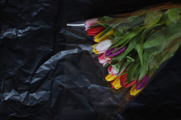 Multi-colored tulips. Bouquet of flowers. Bouquet of tulips. Tulips on a black background.