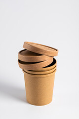 Empty paper soup cup on a white background. Brown food container for ice cream, noodles or other dishes. ecological product that can decompose naturally.