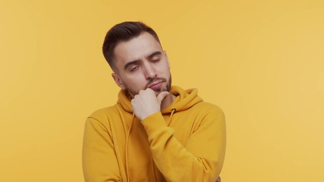 Expressive young man over vibrant background. Studio portrait of borred person.