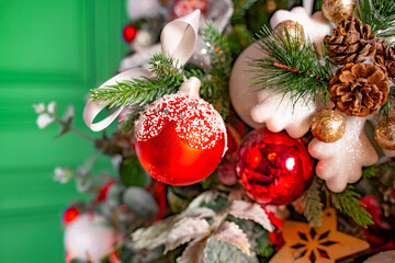 Close-up Red balls of Christmas tree decoration. Christmas tree on green.