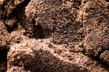 background in the form of a young black instant coffee texture and piece of rock. closeup top view