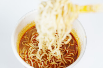 Instant noodle dish in a cup isolated on white background, close up.