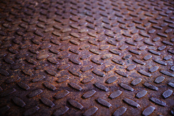Old and rusty metal floor. Texture of a rough metal sheet with a convex pattern.