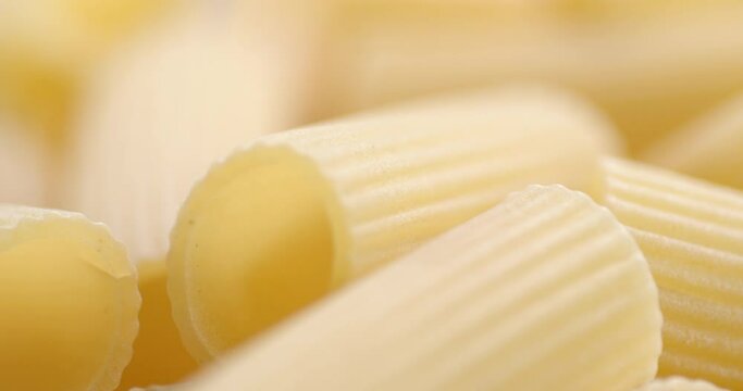 Dry pasta cannelloni on table slowly rotates.