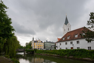 Fototapeta na wymiar Leonhardi church on the river Amper in the bavarian town Fuerstenfeldbruck on cloudy overcast day