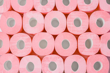 Rolls of pink toilet paper. Abstract background or texture. Large number of rolls of pink toilet paper