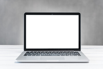 laptop mockup, home and office workspace concept. Laptop computer white blank screen on work table front view. Copy space