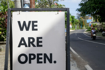 We are open sign on the street. Slowly opening and getting back to normal life after Coronavirus outbreak.