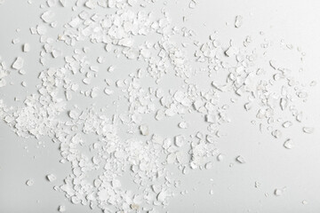  White sea bath salt on a gray background. Spa and personal care concept. background and texture.
