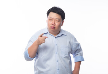 Young Fat Asian business man poiting to camera with funny face isolated on white background.