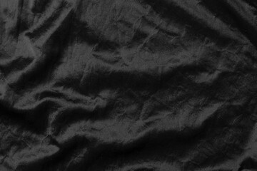 Fototapeta na wymiar Abstract black fabric cloth texture background or liquid wave or wavy folds.
