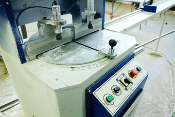 Industrial machine with control panel buttons and switches.