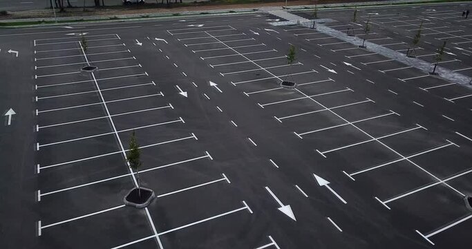 Aerial drone view footage of giant empty parking lot nearly large mall. New quarantine reality