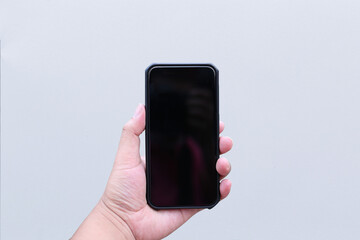 Mobile phone holding on hand isolate on white background. Close up and selective focus.