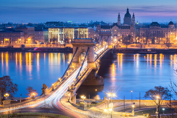 Fototapeta na wymiar St. Stephen's Basilica with Szechenyi Chain Bridge reflect in Danube river, Budapest during twilight