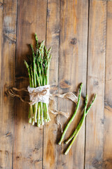 bunch of fresh asparagus on wooden table