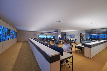 Female operator working in a security data system control room