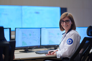 portrait of Female operator in a security data system control room