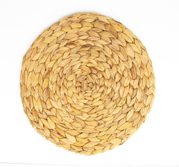 Round woven wicker straw mat isolated on white background