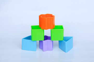Fototapeta premium Isolated children's toy blocks in various shapes made of plastic on white background 