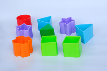 Obraz premium Isolated children's toy blocks in various shapes made of plastic on white background 