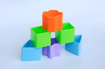 Obraz premium Isolated children's toy blocks in various shapes made of plastic on white background 