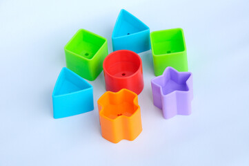 Isolated children's toy blocks in various shapes made of plastic on white background 