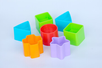 Isolated children's toy blocks in various shapes made of plastic on white background 