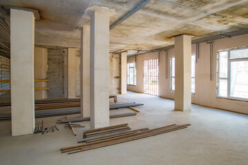 Large room during the repair. Pipes lie on a construction site. Building is ready for decoration. Preparation for communications. Engineering communications in a building under construction