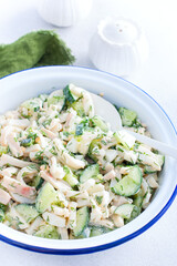 salad with calamari and fresh cucumbers and herbs, selective focus