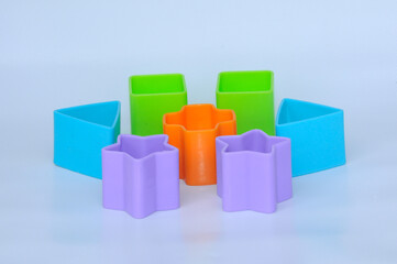 Obraz premium Isolated children's toy blocks in various shapes made of plastic on white background 