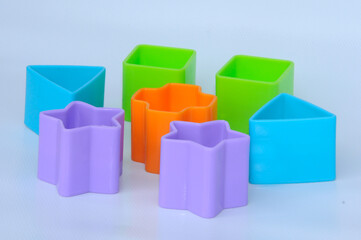 Fototapeta premium Isolated children's toy blocks in various shapes made of plastic on white background 