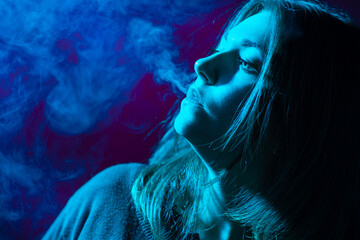 Smoking. The girl blows smoke from cigarettes. Woman with a vape device. Smoke from cigarettes...