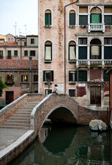 Fototapeta na wymiar A view of a Venetian canal with traditional townhouses.