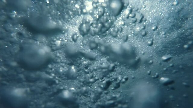 Underwater Bubbles with sunlight through water surface, natural slow motion underwater scene