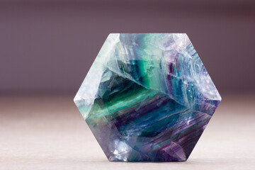 polished flourite crystal in the shape of hexagon
