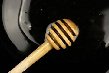 spoon honey bear in a plate on a black background