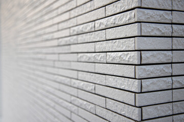 Diagonal white brick wall background.