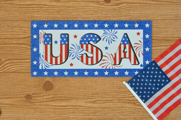 Obraz premium Independence Day July 4th, President's Day, Memorial Day, Labor Day, Veteran's Day, Great America. USA sign in the colors of the flag of the United States on a wooden background with the flag.